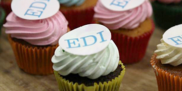 Cupcakes with cream and edible paper with the letters EDI on top